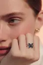 Silver butterfly ring with blue stones.