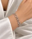 925 sterling silver bracelet with infinity links and white stone-set circular links.