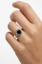 A BVLGARI-style ring in 925 sterling silver, featuring a round black stone.