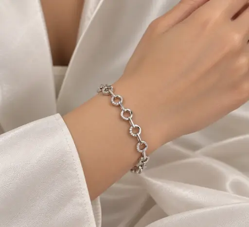 [BRC-004] 925 sterling silver bracelet with circular links partially set with white stones.