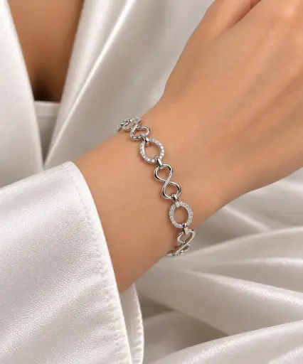 925 sterling silver bracelet with infinity links and white stone-set circular links.